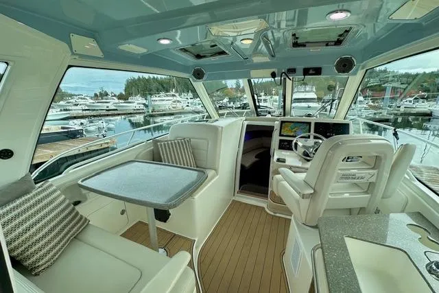 Slide: The Image of Interior of 2021 Boston Whaler 345 Conquest Pilothouse, featuring modern seating and navigation. - 44