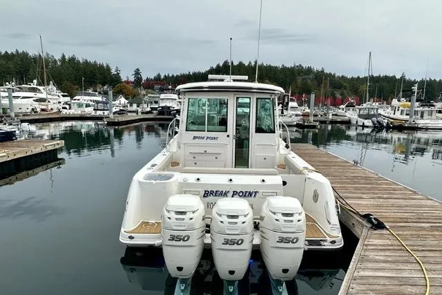Slide: The Image of 2021 Boston Whaler 345 Conquest Pilothouse docked with triple 350 engines. - 46