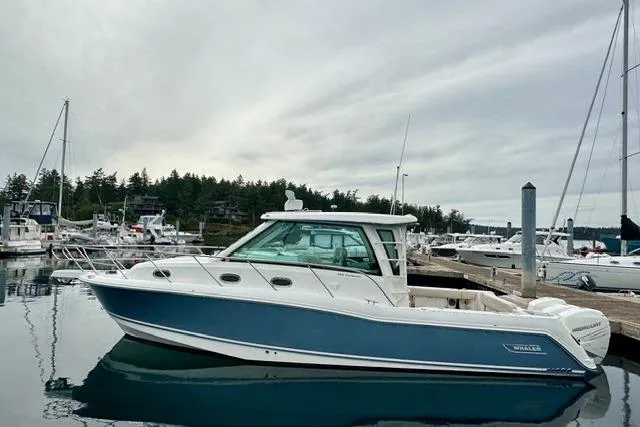 Slide: The Image of 2021 Boston Whaler 345 Conquest Pilothouse docked in a marina, side view. - 48