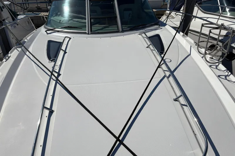 Slide: The Image of 2012 Sea Ray 370 Sundancer docked at a marina under clear blue skies. - 2