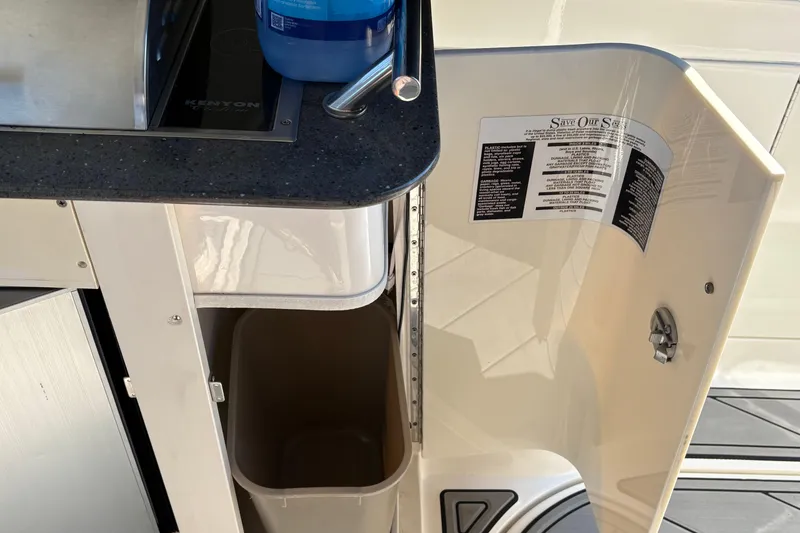 Slide: The Image of Open mini fridge on 2012 Sea Ray 370 Sundancer yacht, showcasing interior storage space. - 20