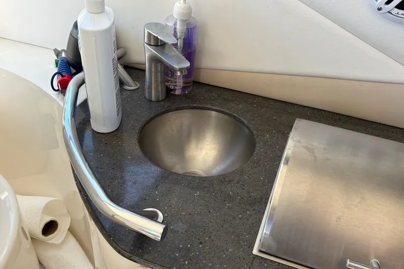 Slide: The Image of Open storage compartment on 2012 Sea Ray 370 Sundancer boat with trash bin. - 21