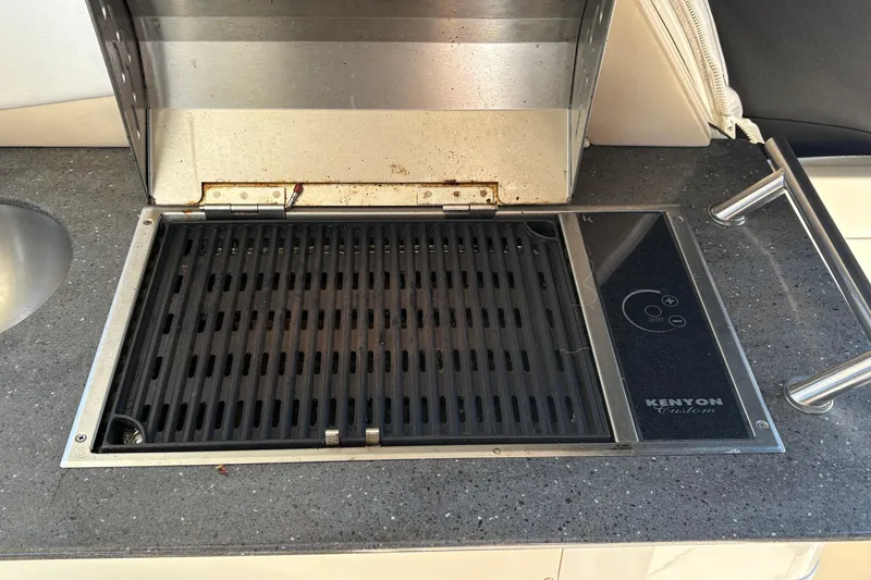 Slide: The Image of 2012 Sea Ray 370 Sundancer sink area with faucet and countertop accessories. - 23