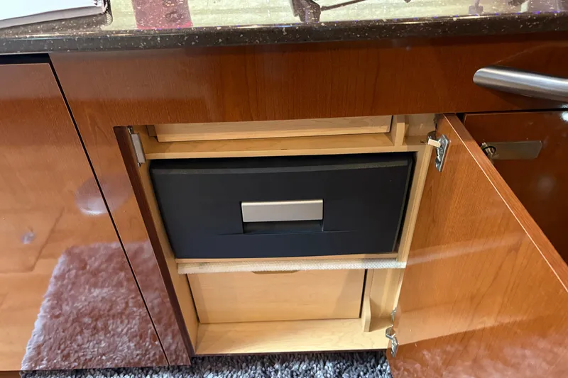 Slide: The Image of 2012 Sea Ray 370 Sundancer yacht bow view at marina, featuring sleek design and water reflections. - 31