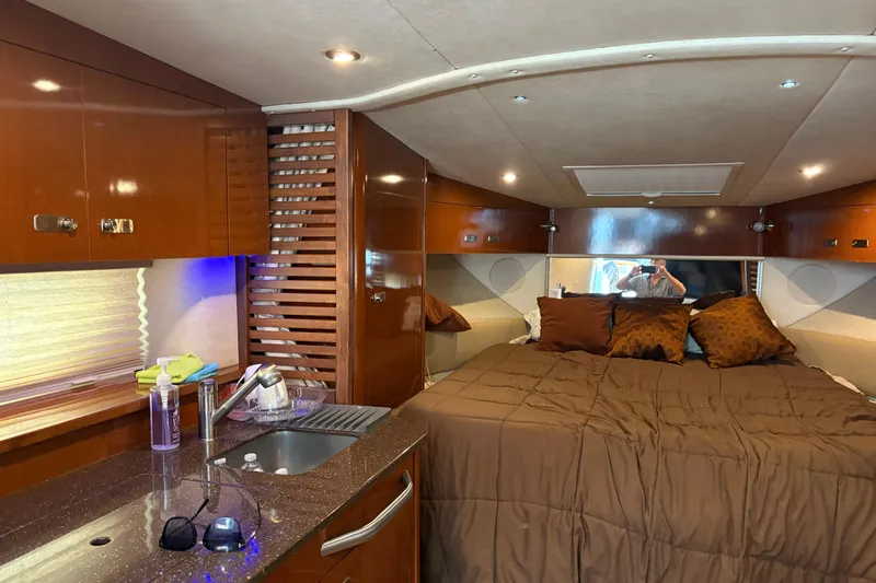Slide: The Image of Anchor compartment of 2012 Sea Ray 370 Sundancer boat, open with visible anchor and mechanism. - 34