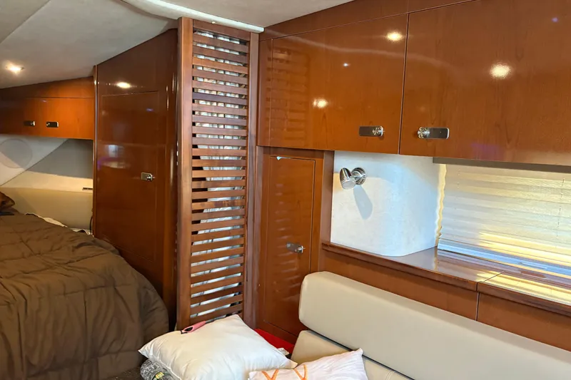 Slide: The Image of Luxurious interior of 2012 Sea Ray 370 Sundancer with cozy bed and elegant seating area. - 36