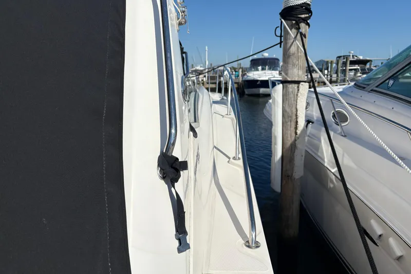 Slide: The Image of Luxurious interior of 2012 Sea Ray 370 Sundancer with beige sofa and decorative pillows. - 37