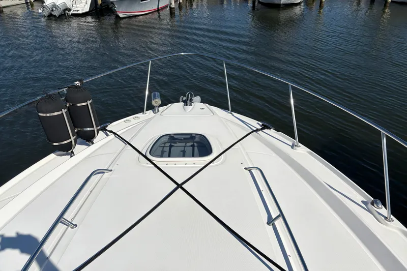 Slide: The Image of Interior of 2012 Sea Ray 370 Sundancer with beige seating and wooden steps. - 39