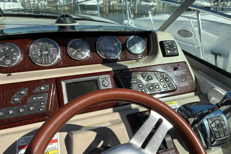 Slide: The Image of 2012 Sea Ray 370 Sundancer boat deck with sleek design and stainless steel railings. - 4