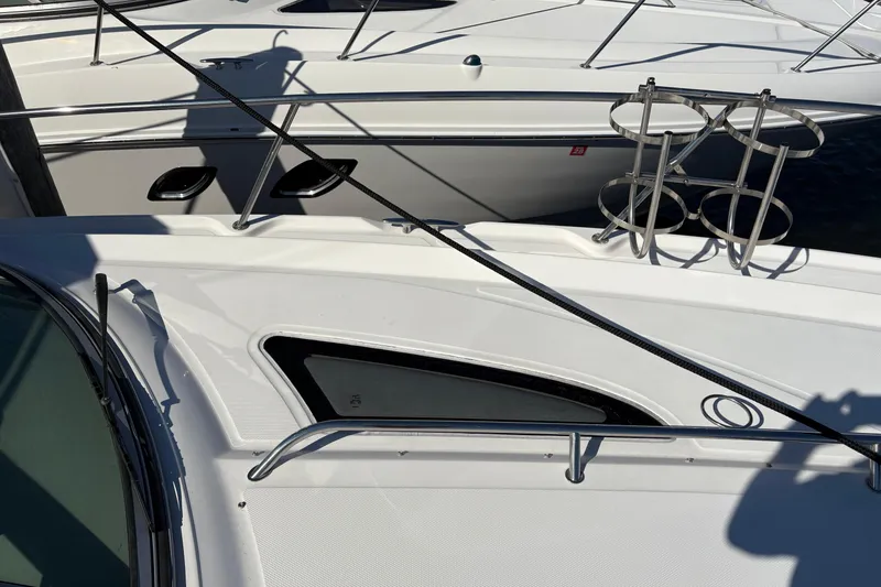 Slide: The Image of Interior of 2012 Sea Ray 370 Sundancer with beige sofa and wooden steps. - 40