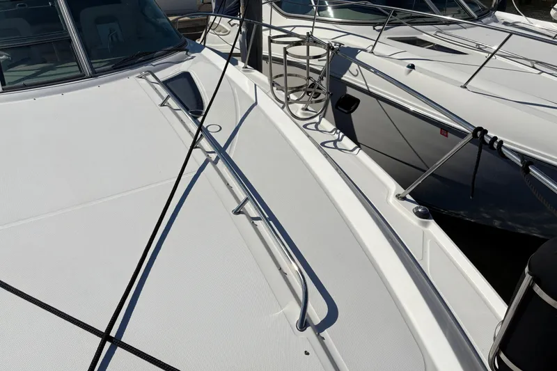 Slide: The Image of Luxurious interior of 2012 Sea Ray 370 Sundancer with wood cabinetry and cozy bedding. - 44