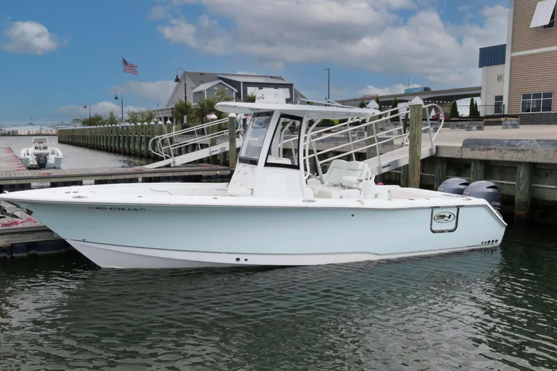 The Image of 2017 Sea Hunt Gamefish 27 Coffin Box boat docked at marina under cloudy sky. - 0
