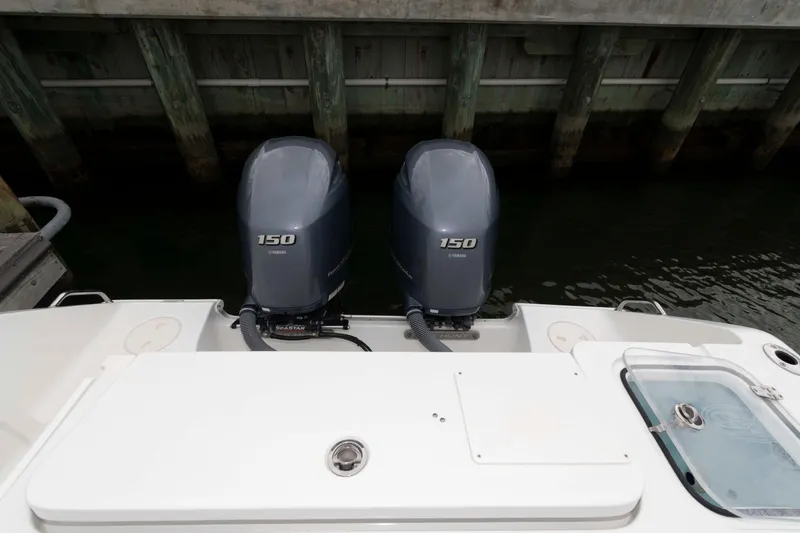 Slide: The Image of 2017 Sea Hunt Gamefish 27 Coffin Box with twin Yamaha 150 engines at dock. - 14