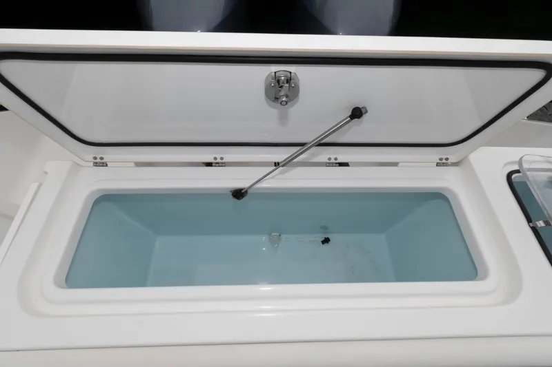 Slide: The Image of Open coffin box on 2017 Sea Hunt Gamefish 27 boat, showcasing interior storage space. - 15