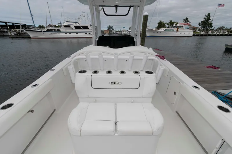 Slide: The Image of 2017 Sea Hunt Gamefish 27 Coffin Box boat interior with rod holders, docked at marina. - 4