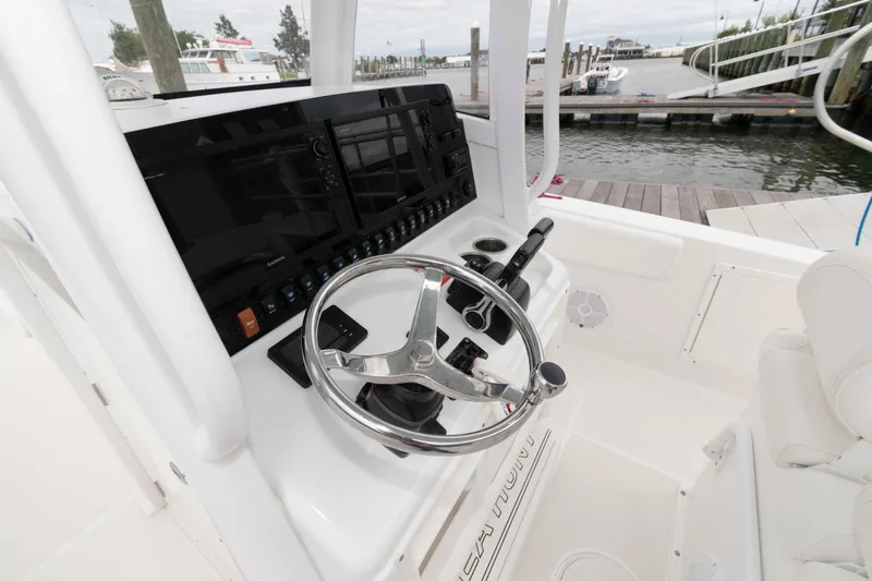 Slide: The Image of 2017 Sea Hunt Gamefish 27 Coffin Box boat helm with steering wheel and control panel. - 7