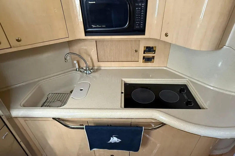 Slide: The Image of Kitchen area of 2000 Sea Ray 380 Sundancer with sink, stove, and microwave. - 10
