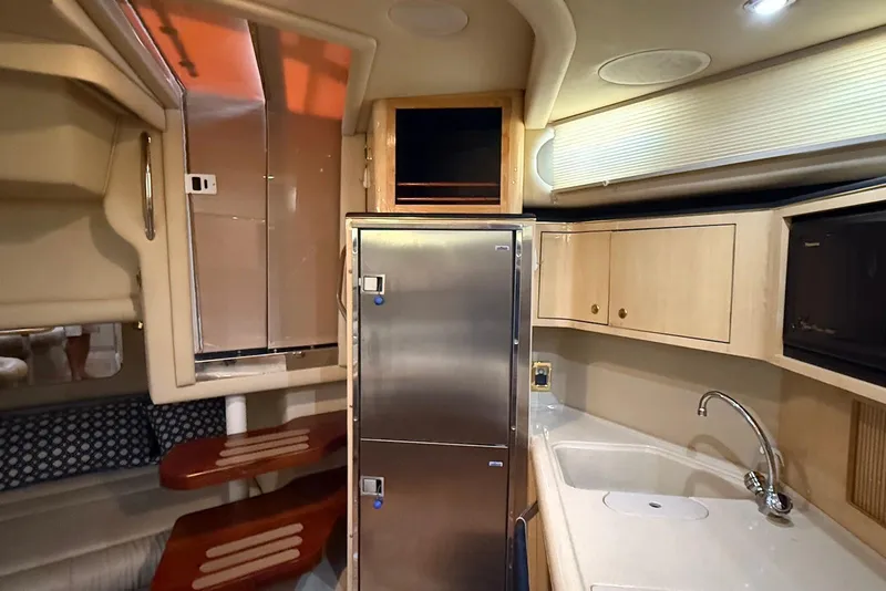 Slide: The Image of Interior of 2000 Sea Ray 380 Sundancer yacht with kitchenette and seating area. - 11