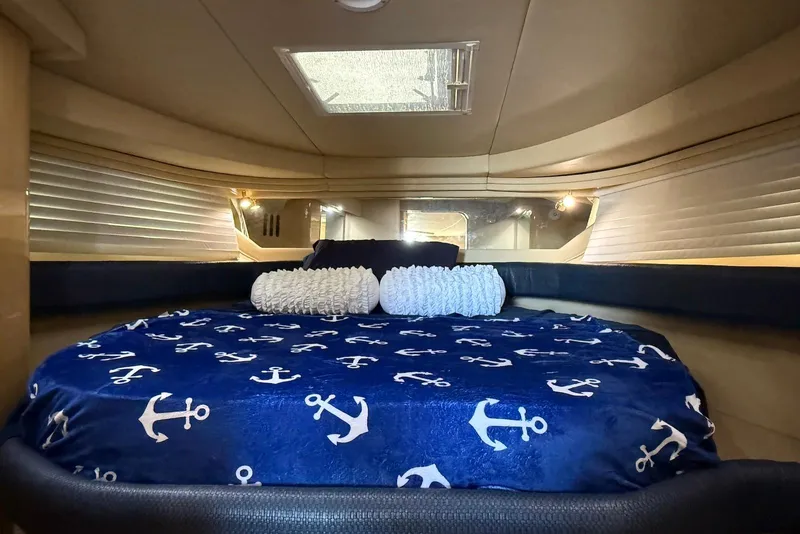 Slide: The Image of Luxurious cabin interior of 2000 Sea Ray 380 Sundancer with nautical-themed bedding. - 12