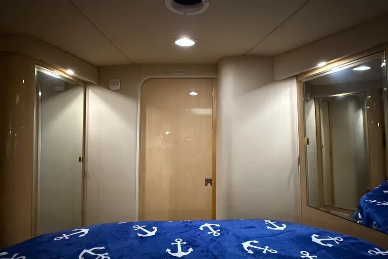 Slide: The Image of Interior cabin of 2000 Sea Ray 380 Sundancer with nautical-themed bedding. - 13