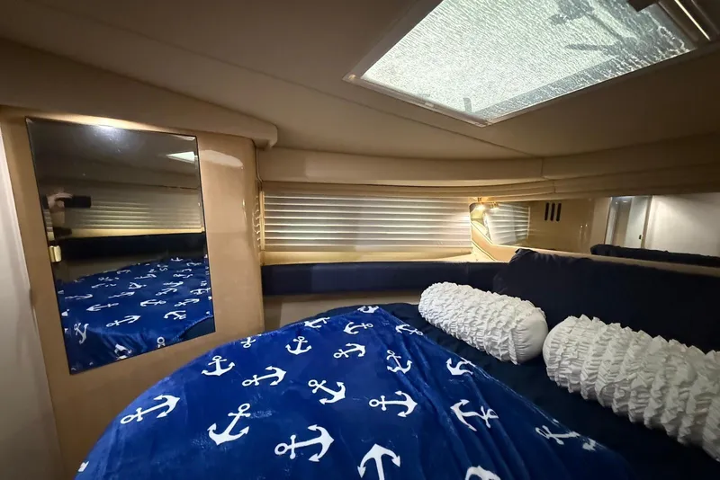 Slide: The Image of Cozy cabin interior of 2000 Sea Ray 380 Sundancer with nautical-themed bedding. - 14