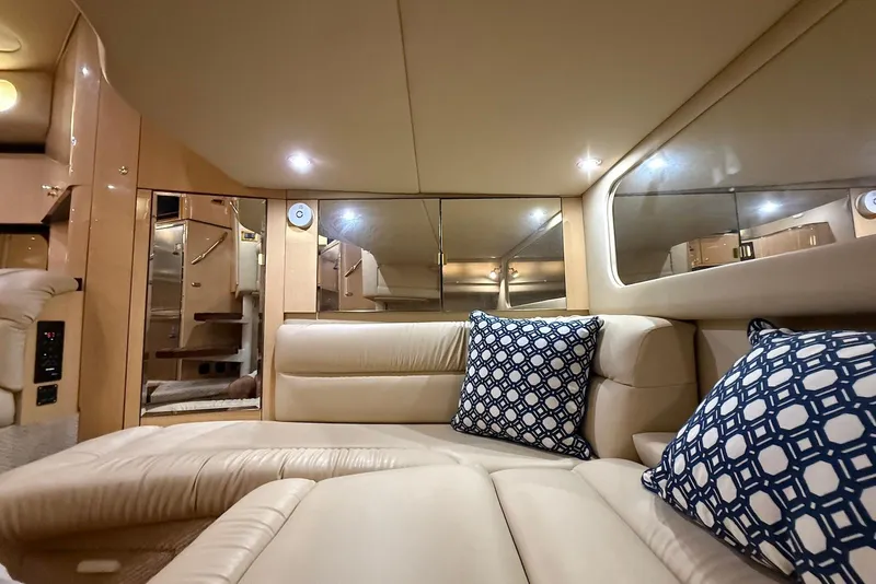 Slide: The Image of Luxurious interior of 2000 Sea Ray 380 Sundancer with plush seating and decorative pillows. - 18