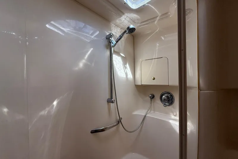 Slide: The Image of Shower area inside 2000 Sea Ray 380 Sundancer yacht, featuring sleek design and modern fixtures. - 21