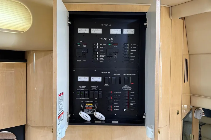 Slide: The Image of Electrical panel inside a 2000 Sea Ray 380 Sundancer yacht, featuring various switches and controls. - 22