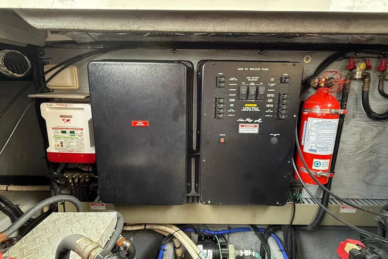 Slide: The Image of Engine room of 2000 Sea Ray 380 Sundancer with control panel and fire extinguisher. - 26