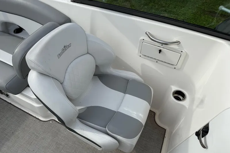 Slide: The Image of 2022 NauticStar 243 DC boat seat with storage compartment and cup holder. - 10