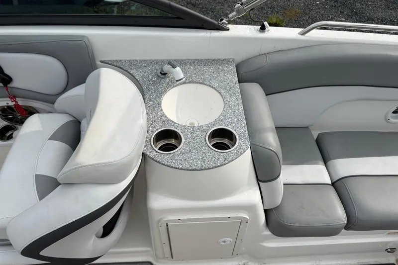 Slide: The Image of 2022 NauticStar 243 DC boat interior with seating and built-in sink. - 12