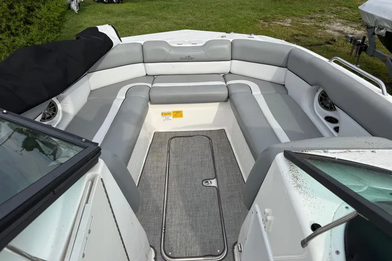 Slide: The Image of 2022 NauticStar 243 DC boat interior with gray seating and carpeted floor. - 16