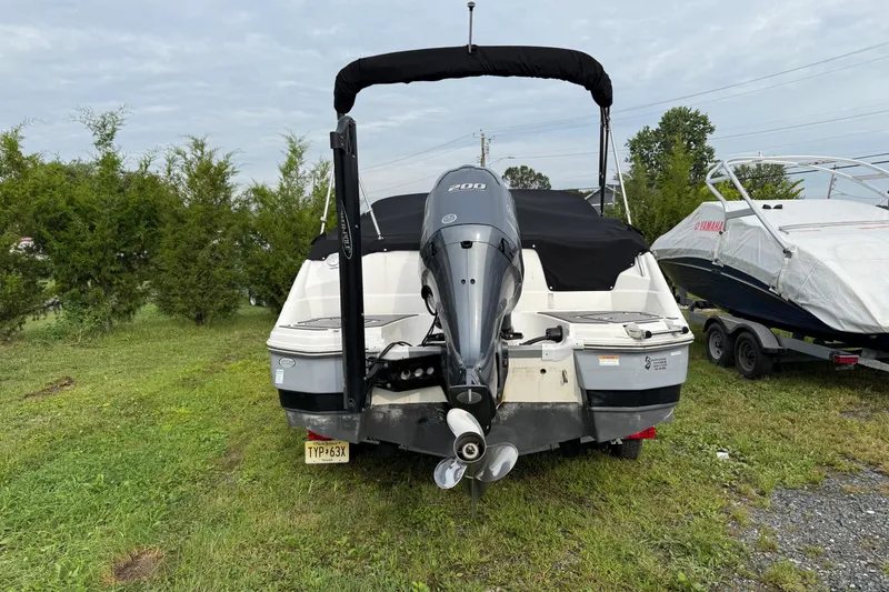 Slide: The Image of 2022 NauticStar 243 DC boat with Yamaha outboard motor, parked on grass. - 4