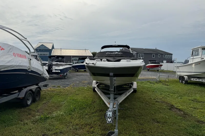 Slide: The Image of 2022 NauticStar 243 DC boat on trailer in outdoor storage area. - 5
