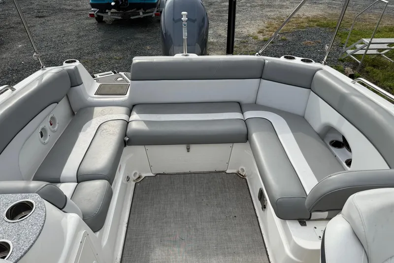 Slide: The Image of 2022 NauticStar 243 DC boat interior with gray seating and cup holders. - 6