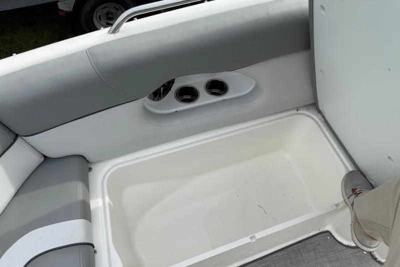Slide: The Image of 2022 NauticStar 243 DC boat interior with seating and storage compartment. - 8