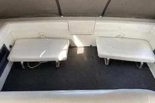 Slide: The Image of 1988 Trojan 8.6 Meter Mid-Cabin boat interior with cushioned seating. - 11