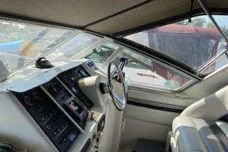 Slide: The Image of 1988 Trojan 8.6 Meter Mid-Cabin boat interior with steering wheel and control panel. - 5