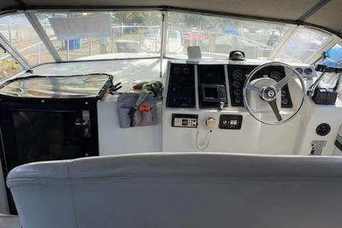 Slide: The Image of 1988 Trojan 8.6 Meter Mid-Cabin boat interior with steering wheel and control panel. - 7