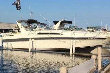 The Image of 1988 Trojan 8.6 Meter Mid-Cabin boat docked in a marina. - 1