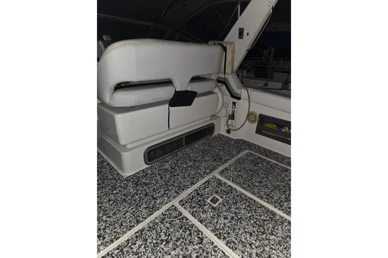 Slide: The Image of 1988 Trojan 8.6 Meter Mid-Cabin interior with white seating and speckled flooring. - 13