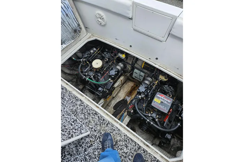 Slide: The Image of Engine compartment of a 1988 Trojan 8.6 Meter Mid-Cabin boat, featuring dual MerCruiser engines. - 16