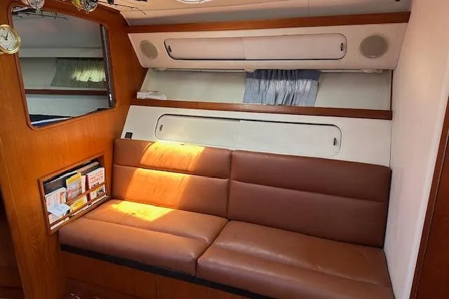 Slide: The Image of 1992 Tiara Yachts 3600 Open interior with brown leather seating and wooden accents. - 12
