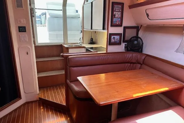 Slide: The Image of Interior of 1992 Tiara Yachts 3600 Open with wooden table and leather seating. - 14