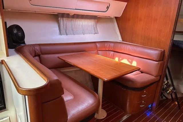 Slide: The Image of 1992 Tiara Yachts 3600 Open interior with leather seating and wooden table. - 19