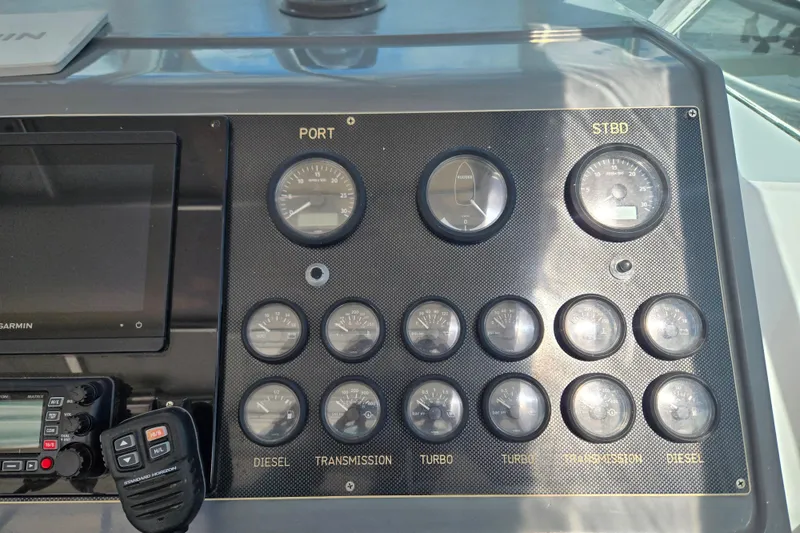 Slide: The Image of Control panel of a 1992 Tiara Yachts 3600 Open with gauges and navigation equipment. - 23