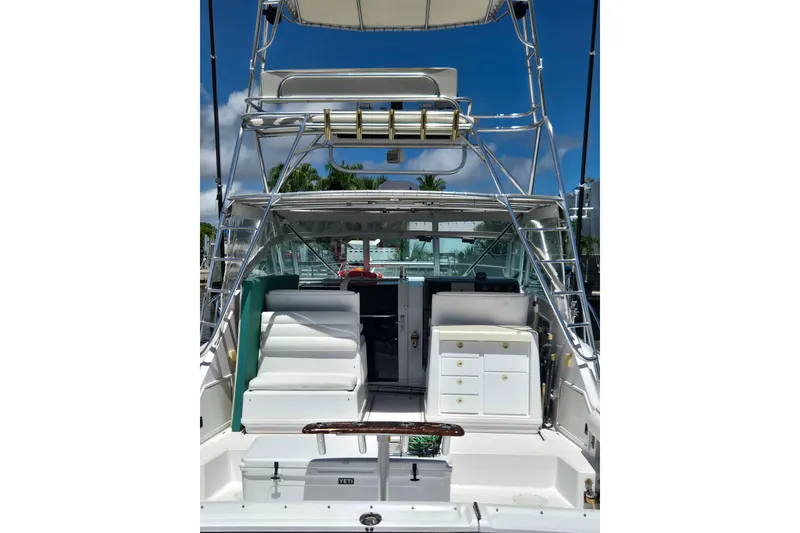 Slide: The Image of 1992 Tiara Yachts 3600 Open boat interior with seating and storage, under a clear blue sky. - 5