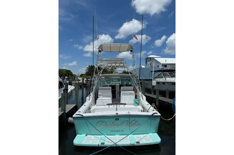 Slide: The Image of 1992 Tiara Yachts 3600 Open docked under a clear blue sky. - 7