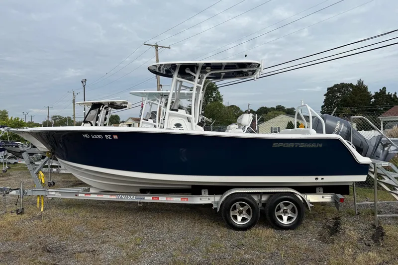 Slide: The Image of 2015 Sportsman Heritage 231 Center Console boat on trailer, parked outdoors. - 1