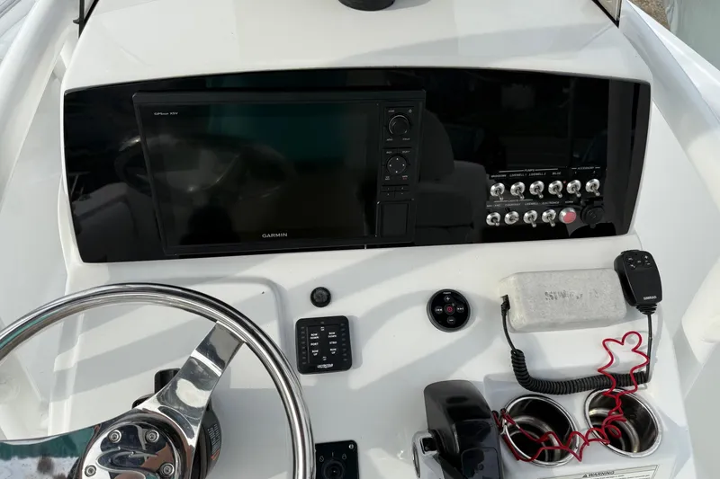 Slide: The Image of 2015 Sportsman Heritage 231 Center Console dashboard with Garmin display and controls. - 10